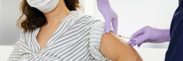Nurse giving a flu vaccination to a patient in a clinic