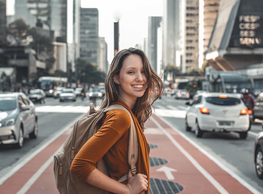 woman smiling and walking on the road